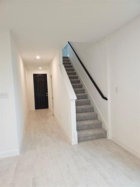 Entryway with stairs and recessed lighting