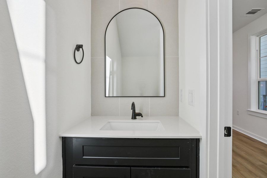 Bathroom featuring vanity and wood finished floors