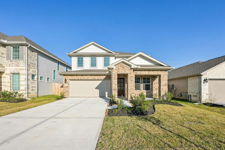 Front exterior of a new home in Landing Meadows - Premier Series, New Caney, TX, highlighting curb appeal (Image 20).