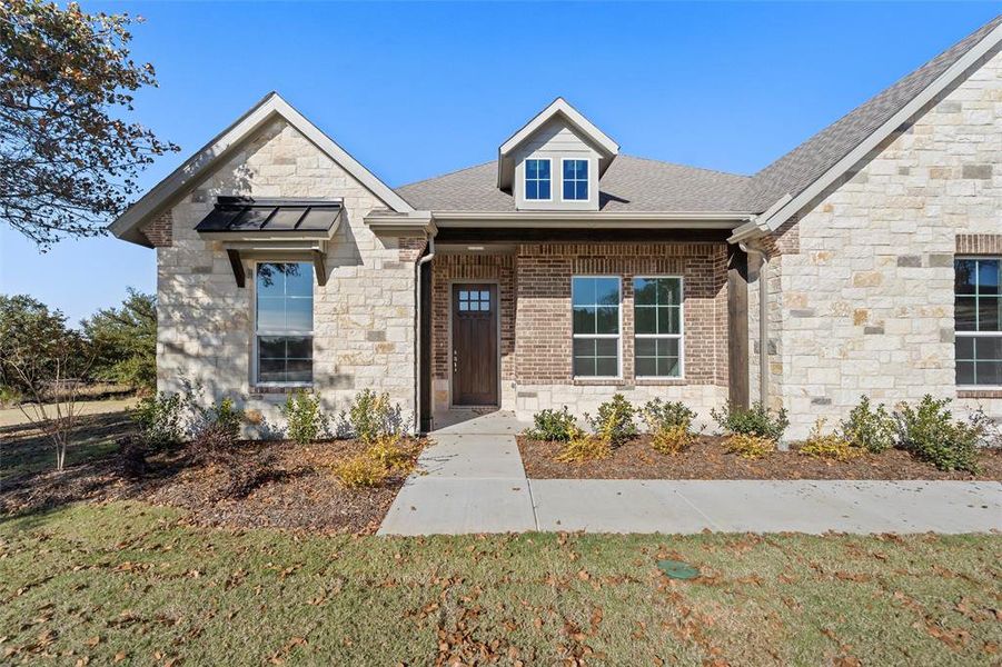 Front exterior of a new home in Oak Grove Addition, Springtown, TX, highlighting curb appeal (Image 24).