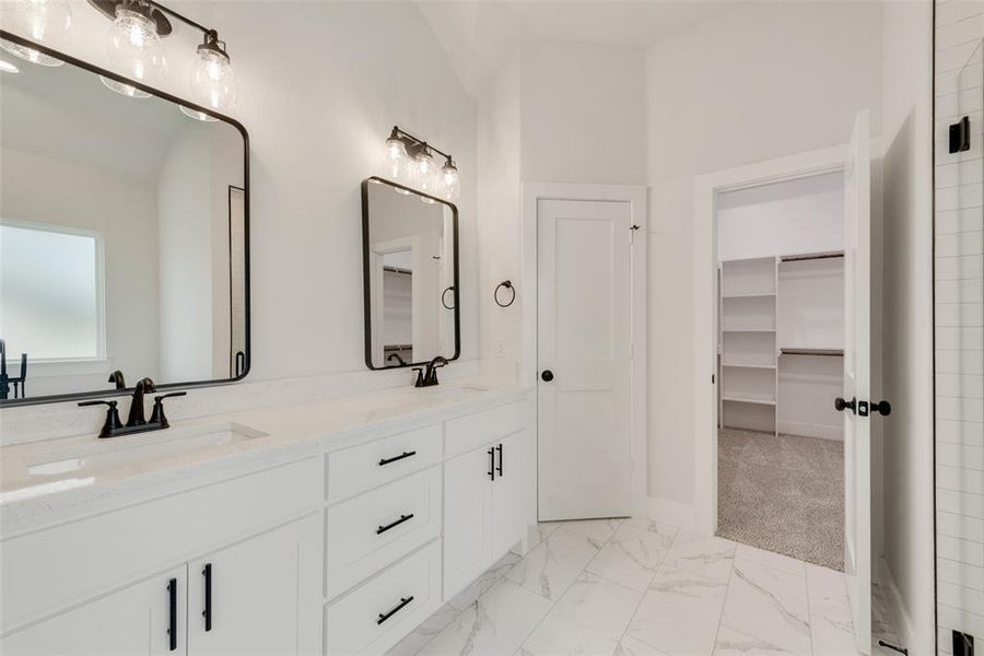 Bathroom featuring tile patterned flooring and dual bowl vanity