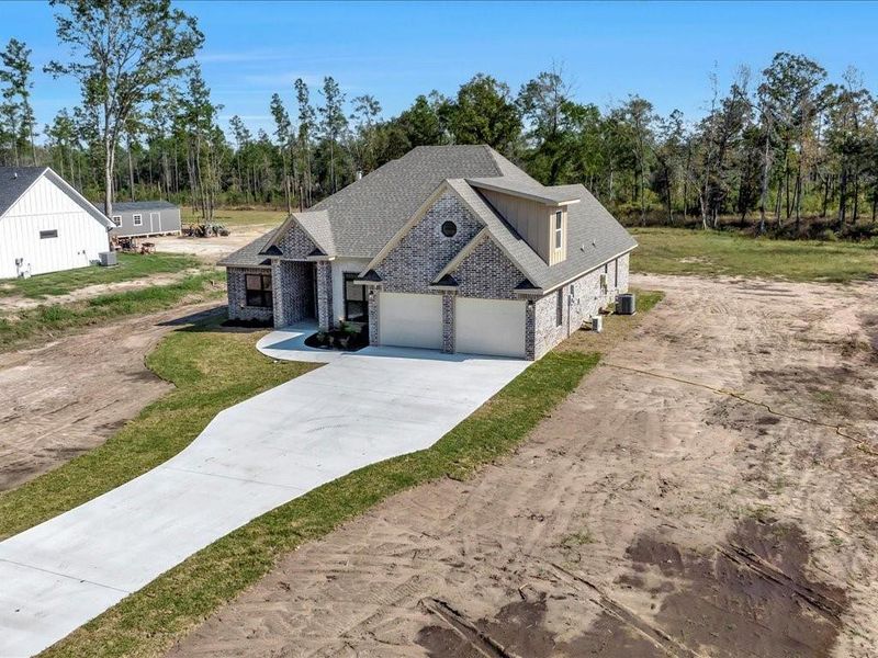 Front exterior of a new home in , Diboll, TX, highlighting curb appeal (Image 23). Front exterior of a new home in , Diboll, TX, highlighting curb appeal (Image 23).