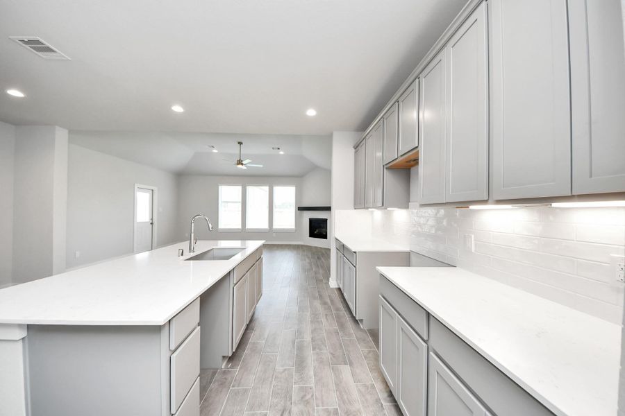 Step into the dream kitchen you've always wanted! This generously spacious culinary haven features a massive granite island, high ceilings, soft-close cabinets, granite countertops, stainless steel appliances, a sleek tile backsplash, and recessed lighting. Step into the dream kitchen you've always wanted! This generously spacious culinary haven features a massive granite island, high ceilings, soft-close cabinets, granite countertops, stainless steel appliances, a sleek tile backsplash, and recessed lighting.