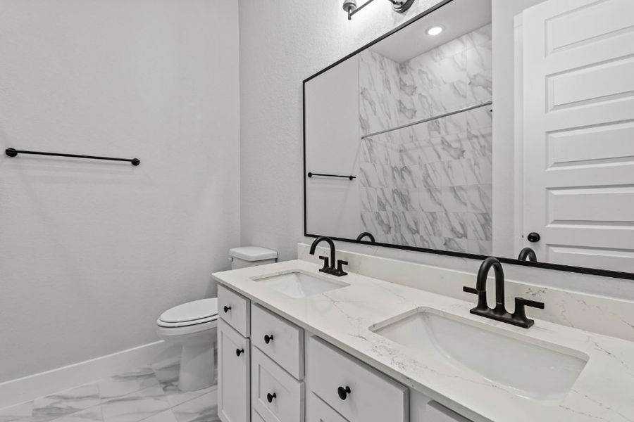 A bathroom with a large mirror.