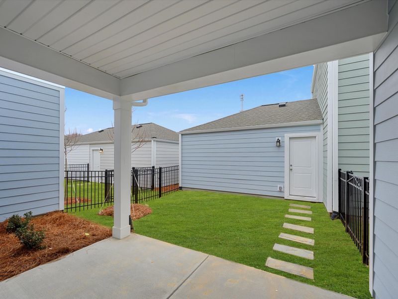 Exterior details and patio area of a home in North Creek Village - Townhomes, Huntersville (Image 4).