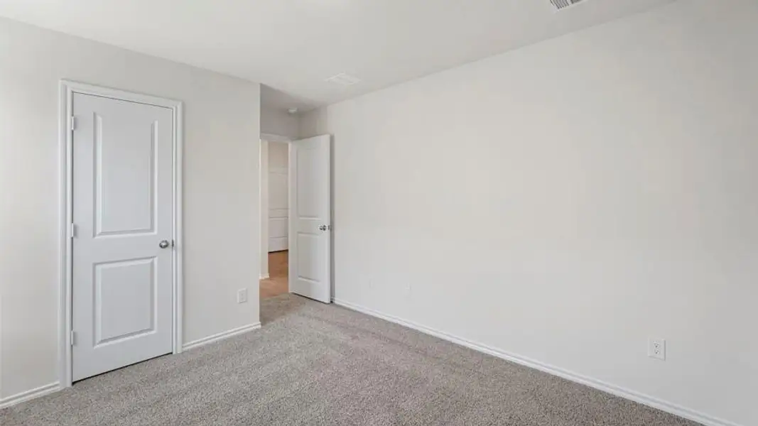 Interior space featuring light gray carpeting, white walls, and white trim