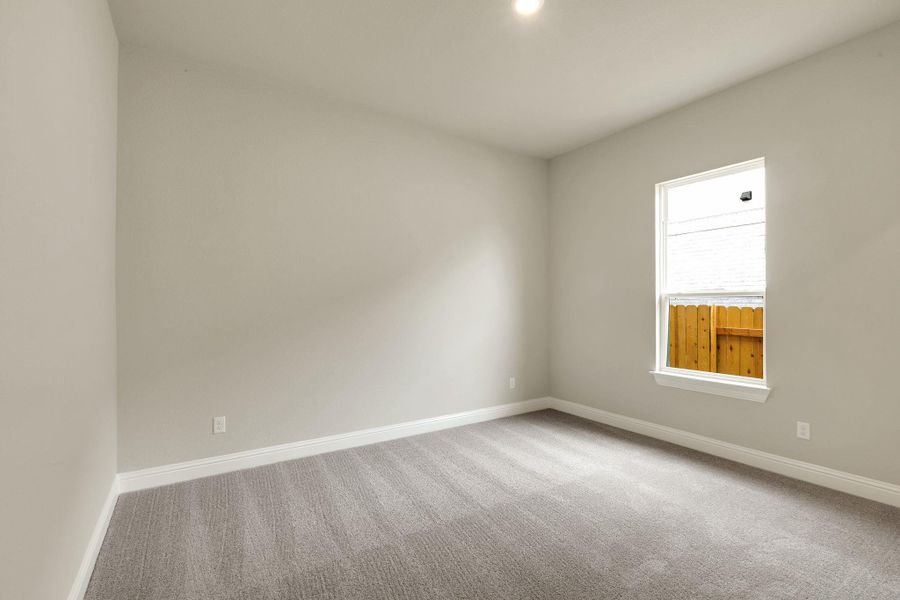 Carpeted empty room featuring baseboards Carpeted empty room featuring baseboards