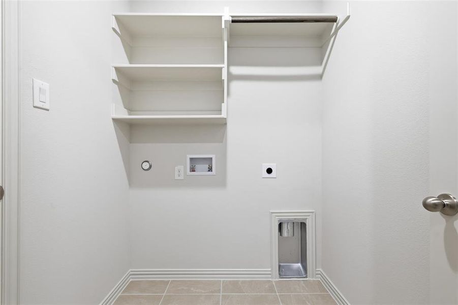 Laundry room featuring electric dryer hookup, hookup for a washing machine, and light tile patterned flooring