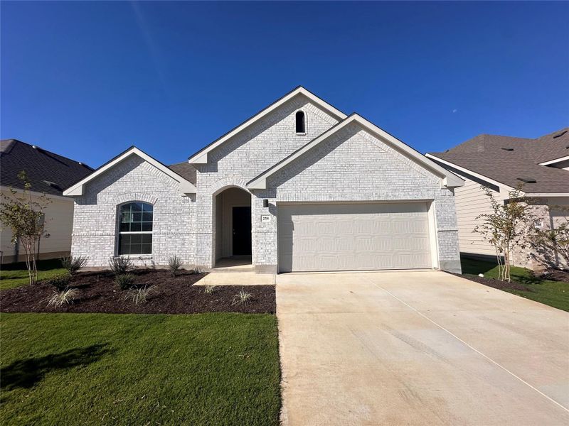 View of front facade featuring concrete driveway, a garage, a front yard, and brick siding View of front facade featuring concrete driveway, a garage, a front yard, and brick siding