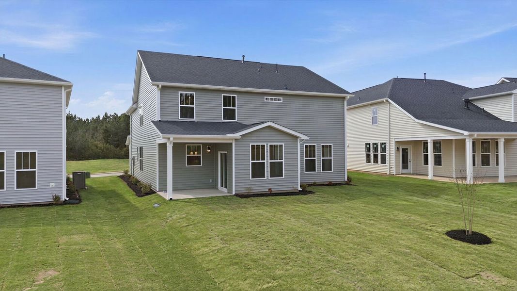 Highly functional rear covered porch adds memorable living space to this elegant home at the Foxbank community