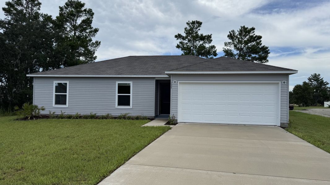 Front exterior of a new home in Poinciana, Kissimmee, FL, highlighting curb appeal (Image 17).