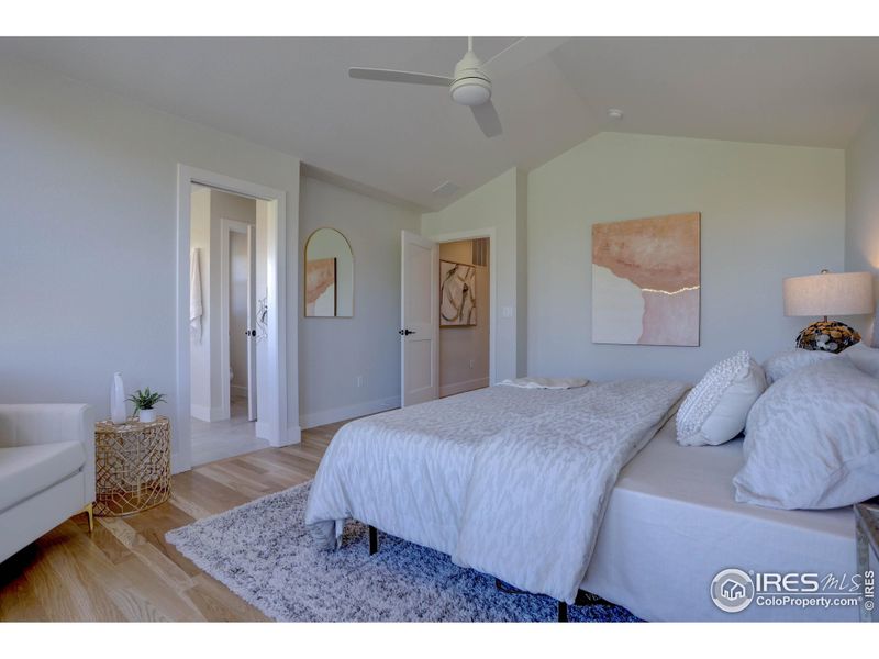 Primary bedroom with a ceiling fan and an ensuite bathroom