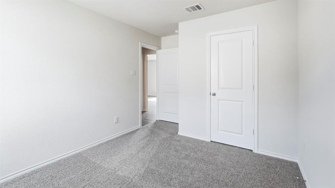Unfurnished bedroom featuring carpet flooring and baseboards Unfurnished bedroom featuring carpet flooring and baseboards