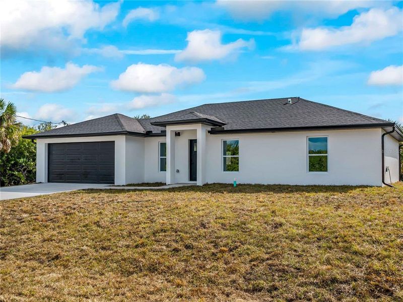 Front exterior of a new home in , Port Charlotte, FL, highlighting curb appeal (Image 25).