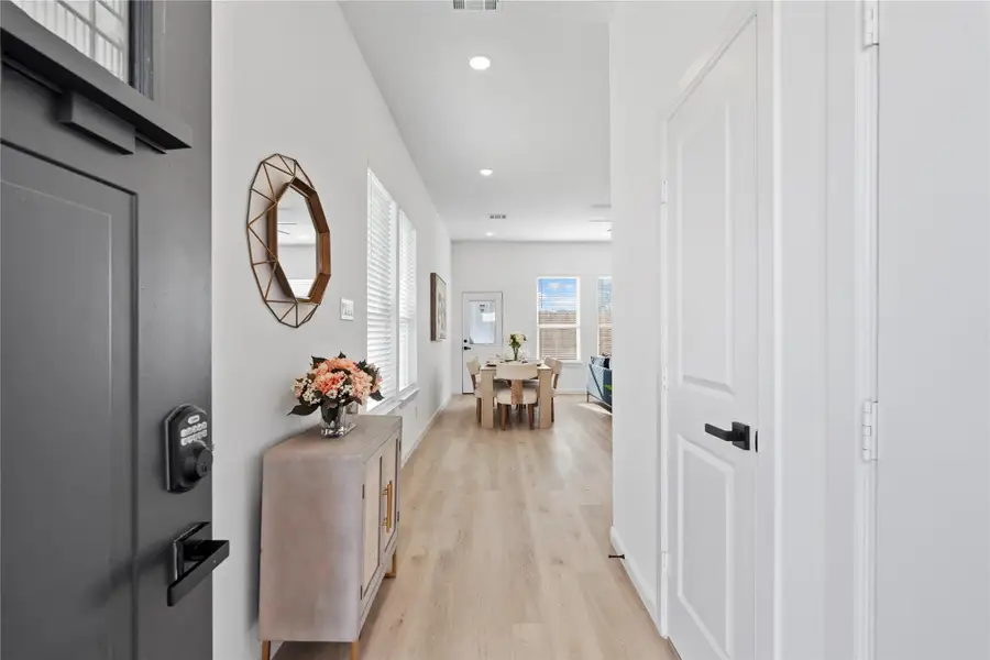 Step inside through a smart lock entry — added security and convenience before opening into the bright living area. Step inside through a smart lock entry — added security and convenience before opening into the bright living area.