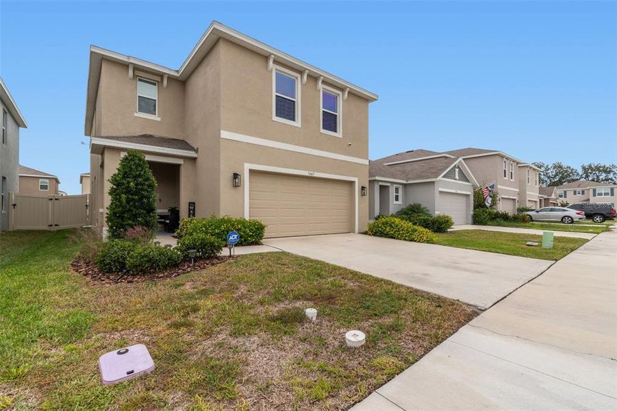 Front exterior of a new home in Westgate at Avalon Park, Wesley Chapel, FL, highlighting curb appeal (Image 27).