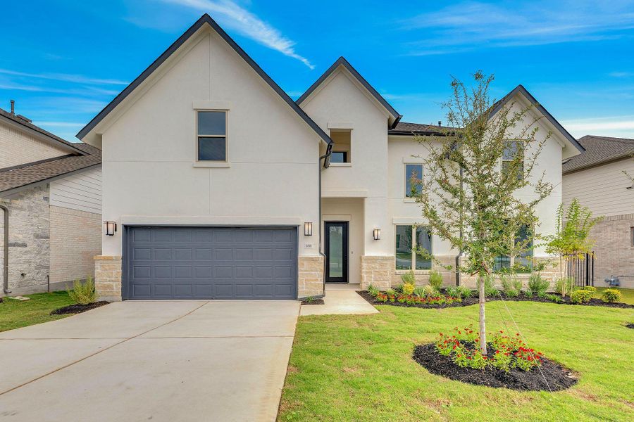Front exterior of a new home in Santa Rita Ranch, Liberty Hill, TX, highlighting curb appeal (Image 2). Front exterior of a new home in Santa Rita Ranch, Liberty Hill, TX, highlighting curb appeal (Image 2).