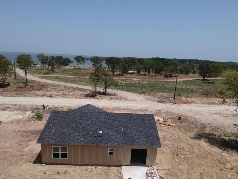 View of yard with a rural view and a water view