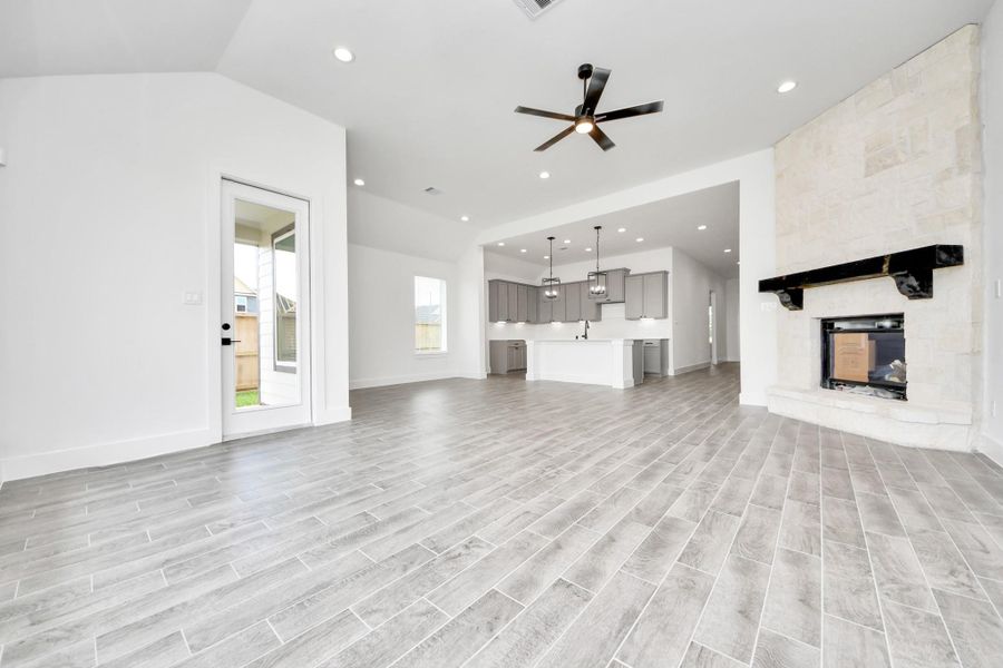 Family room flooded with natural light through the expansive windows. The premium tile flooring adds a touch of luxury to the space, creating the perfect setting for relaxing moments and cherished gatherings with loved ones. Family room flooded with natural light through the expansive windows. The premium tile flooring adds a touch of luxury to the space, creating the perfect setting for relaxing moments and cherished gatherings with loved ones.