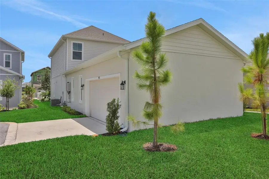 Front exterior of a new home in Bungalow Walk at Lakewood Ranch, Sarasota, FL, highlighting curb appeal (Image 21).