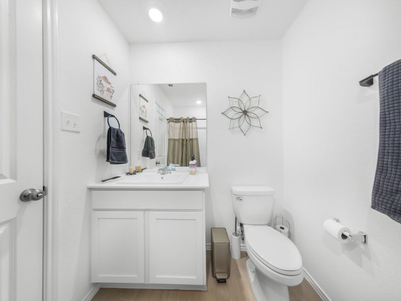 Bathroom featuring a shower with curtain, vanity, light wood-type flooring, and recessed lighting
