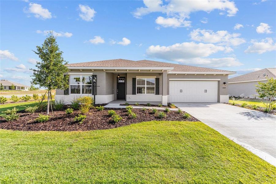 Front exterior of a new home in , Ocala, FL, highlighting curb appeal (Image 1). Front exterior of a new home in , Ocala, FL, highlighting curb appeal (Image 1).