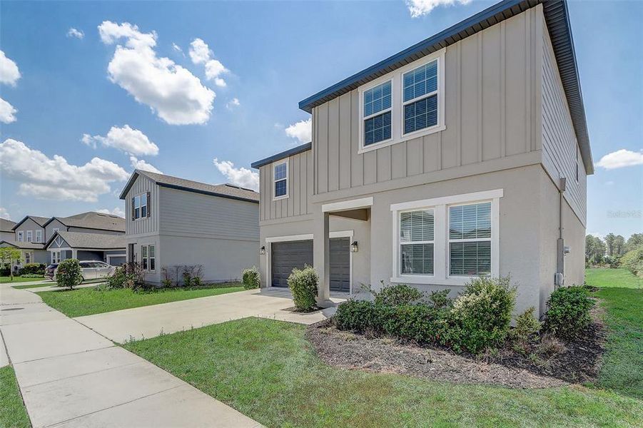 Front exterior of a new home in Glen at West Haven, Davenport, FL, highlighting curb appeal (Image 26).