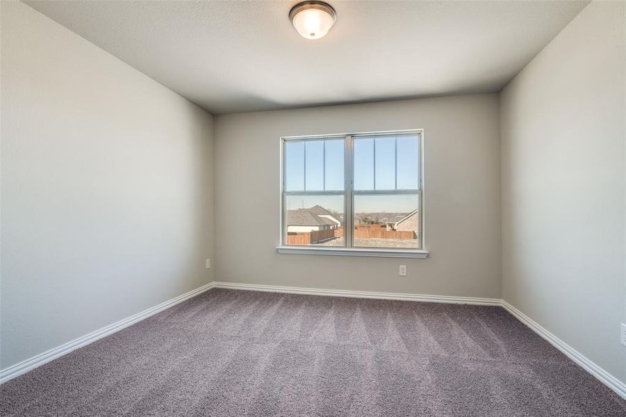 Carpeted empty room featuring baseboards Carpeted empty room featuring baseboards