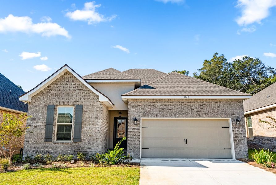 Front exterior of a new home in Sentinel Ridge, Pace, FL, highlighting curb appeal (Image 15). Front exterior of a new home in Sentinel Ridge, Pace, FL, highlighting curb appeal (Image 15).