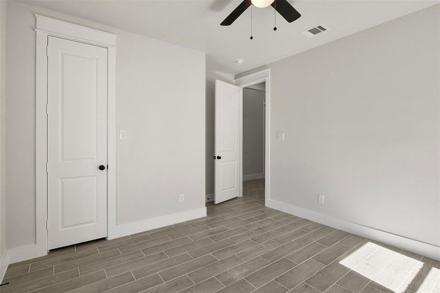 Unfurnished bedroom featuring ceiling fan and hardwood / wood-style flooring