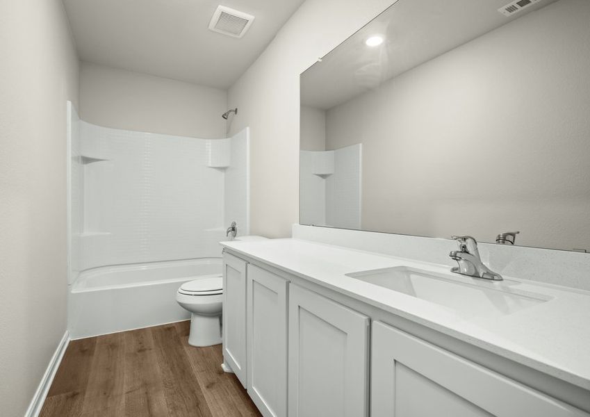 The secondary bathroom has a sprawling vanity and shower tub combo. The secondary bathroom has a sprawling vanity and shower tub combo.