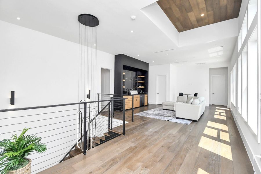 Upstairs has luxurious wood throughout and a massive game room with additional wet bar upstairs.