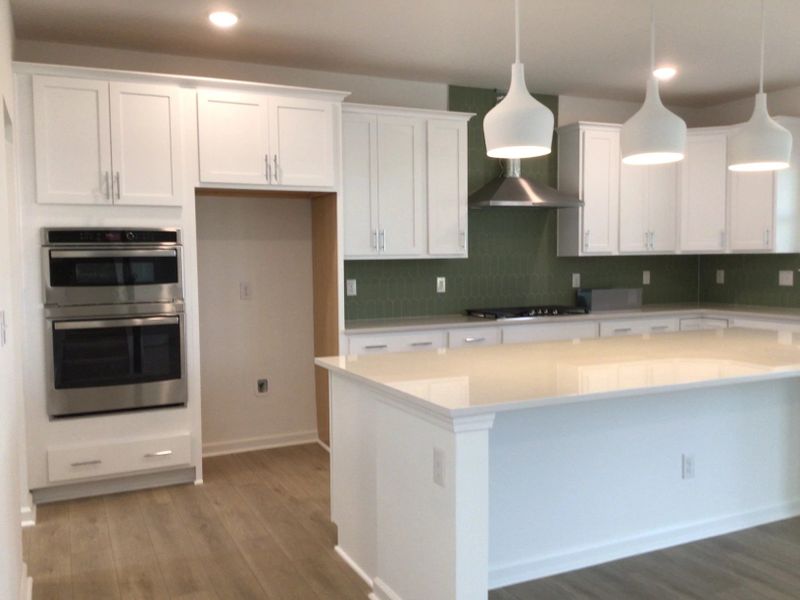 Kitchen featuring the AW Collection® Coastal - White cabinets and sea-glass tile backsplash.