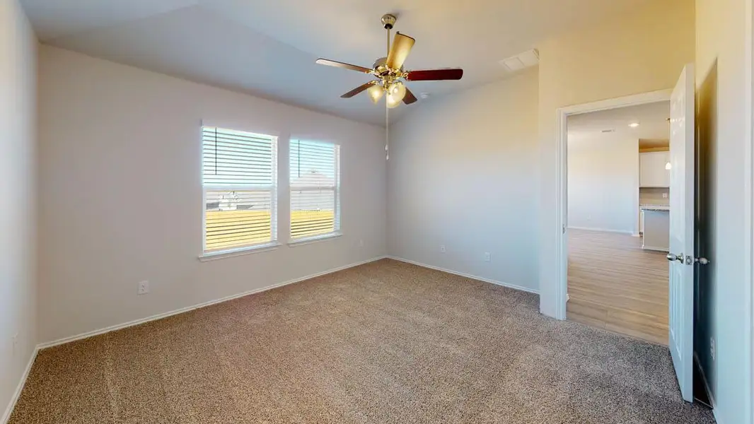 Unfurnished room with light colored carpet, ceiling fan, and lofted ceiling Unfurnished room with light colored carpet, ceiling fan, and lofted ceiling