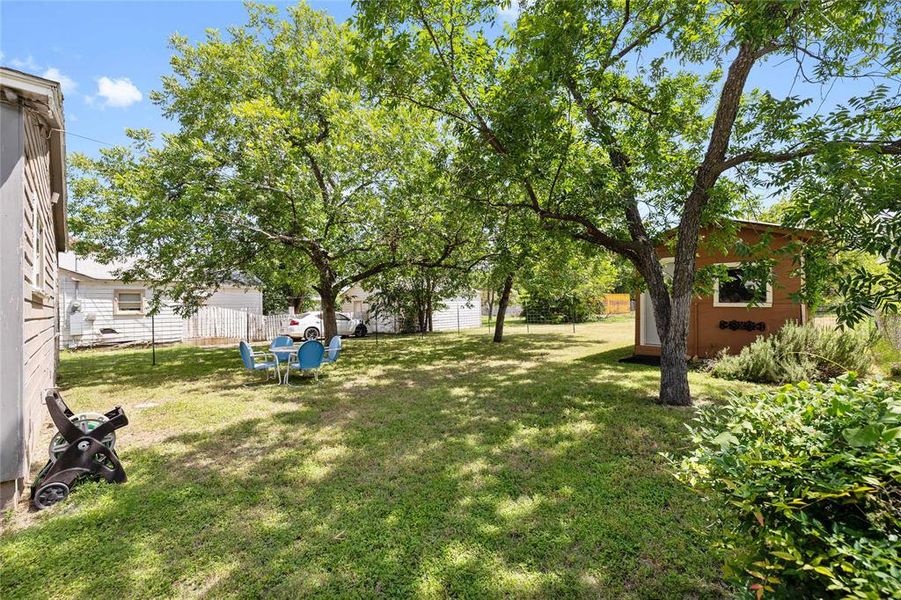 Fenced backyard with an outbuilding Fenced backyard with an outbuilding