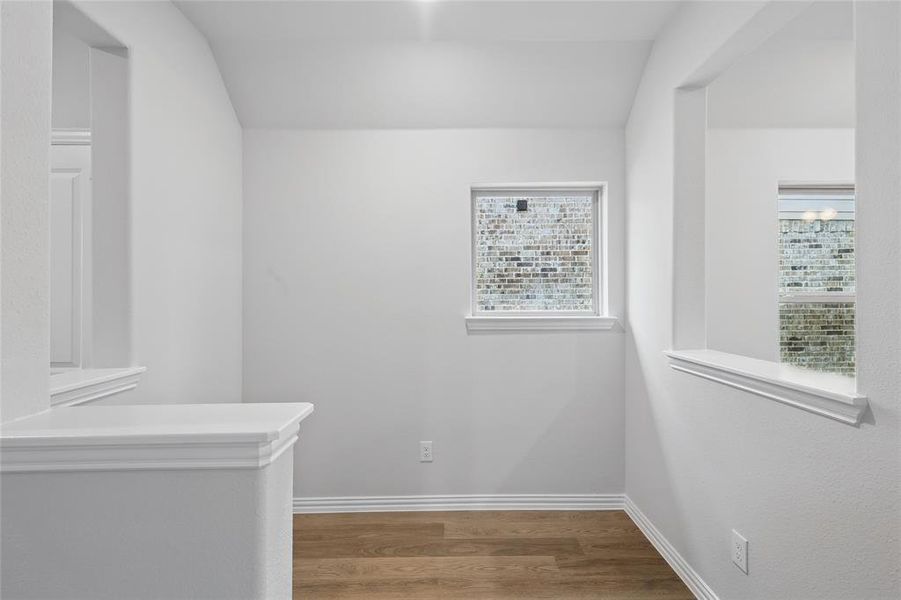 Hall with wood finished floors and baseboards
