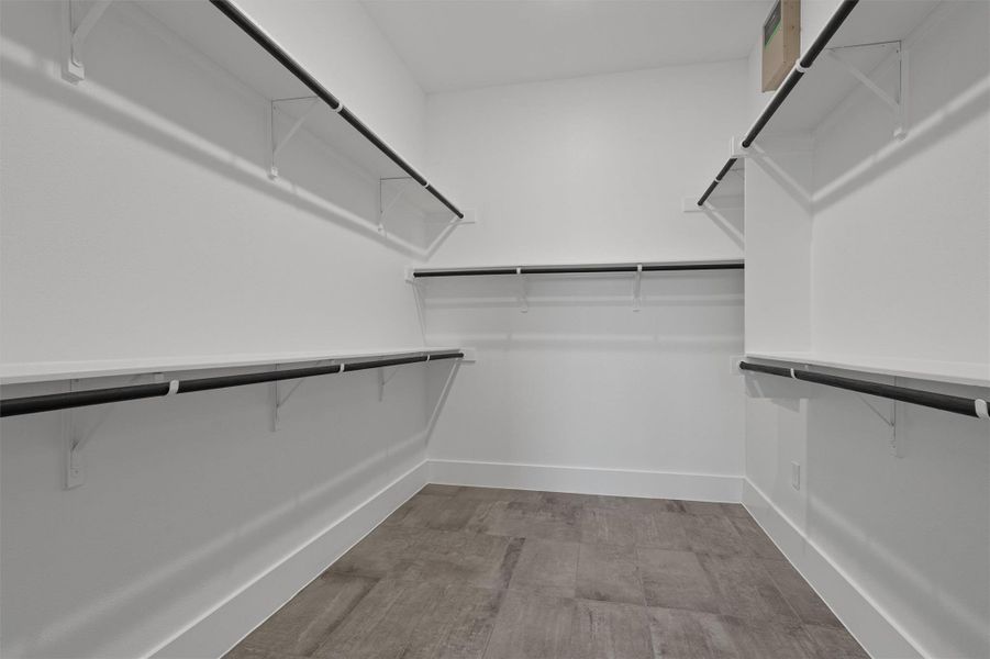Spacious closet with light wood-type flooring Spacious closet with light wood-type flooring