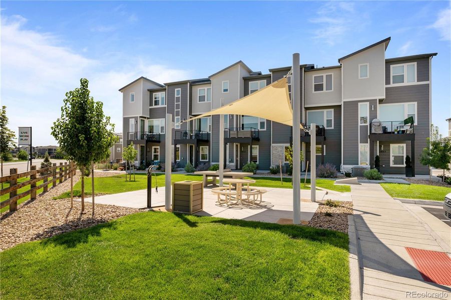 Thoughtfully designed outdoor gathering space with shade structure, picnic seating, and landscaped surroundings. Thoughtfully designed outdoor gathering space with shade structure, picnic seating, and landscaped surroundings.