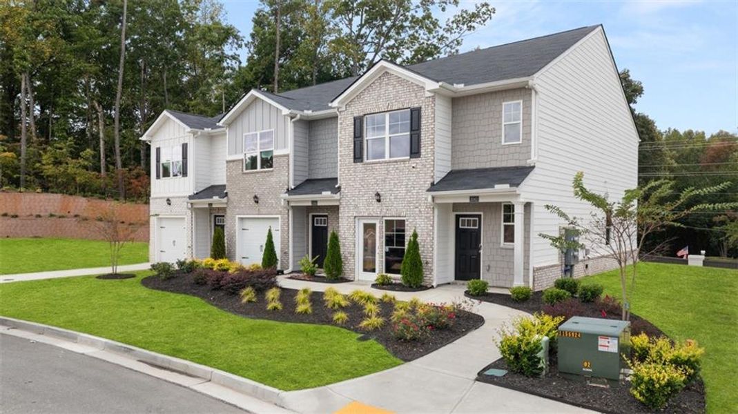 Front exterior of a new home in Young's Crossing, Stone Mountain, GA, highlighting curb appeal (Image 25).