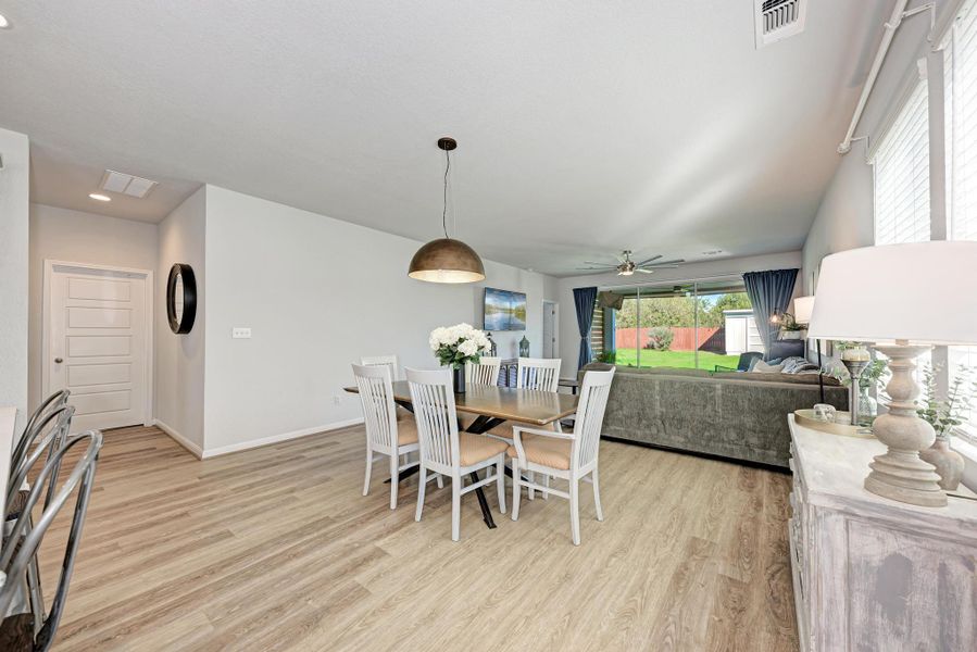 Dining area with light wood-type flooring and a ceiling fan