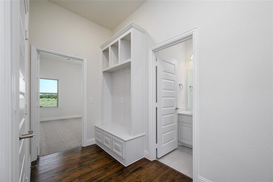 Mudroom with dark hardwood / wood-style flooring