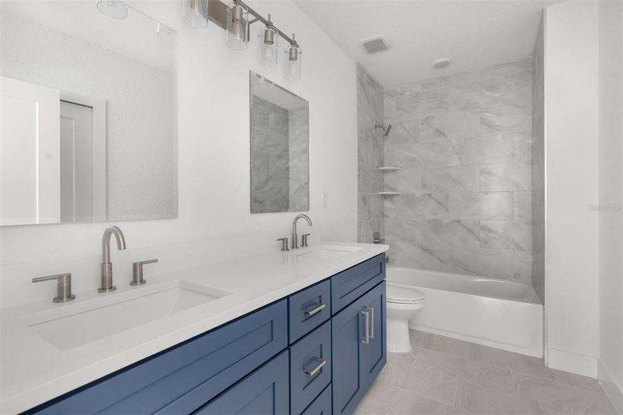 Second bathroom. Dual Sinks. Shower/tub combo. Tiled walls.