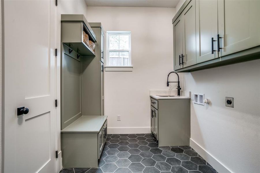 Laundry room with sink, washer hookup, cabinets, hookup for an electric dryer, and dark tile patterned floors