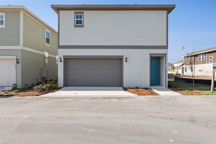 Front exterior of a new home in Laureate Park (Craft Homes), Orlando, FL, highlighting curb appeal (Image 19).