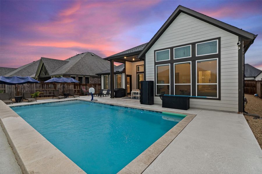 Enjoy a resort-style backyard with heated pool, covered patio, and professional landscaping. Enjoy a resort-style backyard with heated pool, covered patio, and professional landscaping.