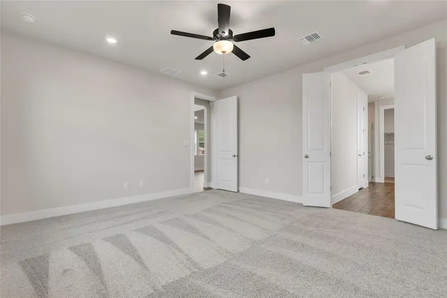 A quiet bedroom retreat with plush carpeting and convenient interior access to a private closet.