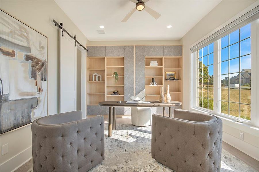 Office area with a barn door, ceiling fan, and recessed lighting Office area with a barn door, ceiling fan, and recessed lighting