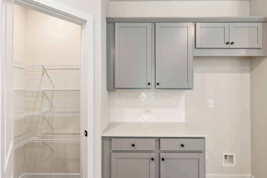 A white kitchen with white cabinets. A white kitchen with white cabinets.