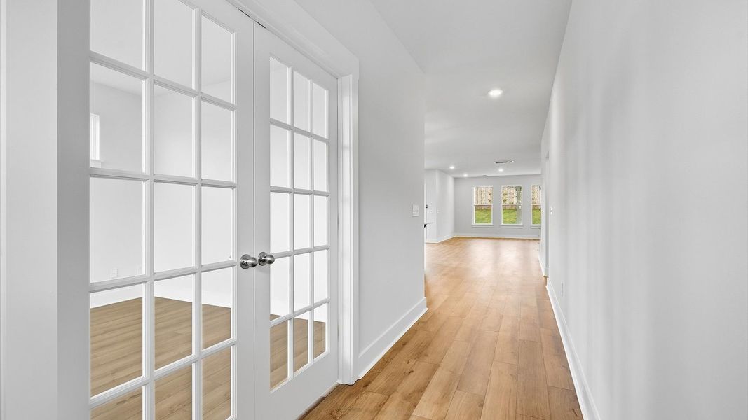 Superior design begins at the front door with a hardwood floor foyer and elegant sightlines at the Woodglen community