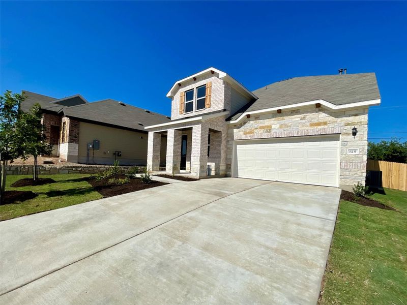 Front exterior of a new home in Covered Bridge, Hutto, TX, highlighting curb appeal (Image 21). Front exterior of a new home in Covered Bridge, Hutto, TX, highlighting curb appeal (Image 21).